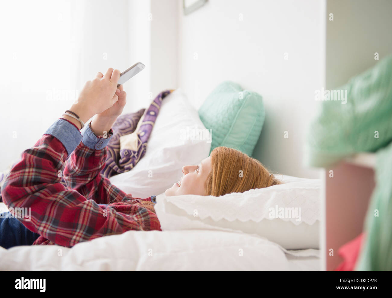 Girl (12-13) using mobile phone Stock Photo
