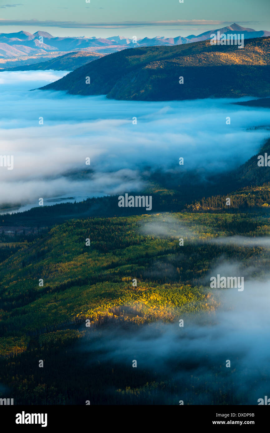 Mist in the valley of the Yukon River at dawn, downstream of Dawson City from Dome Hill, Yukon Territories, Canada Stock Photo