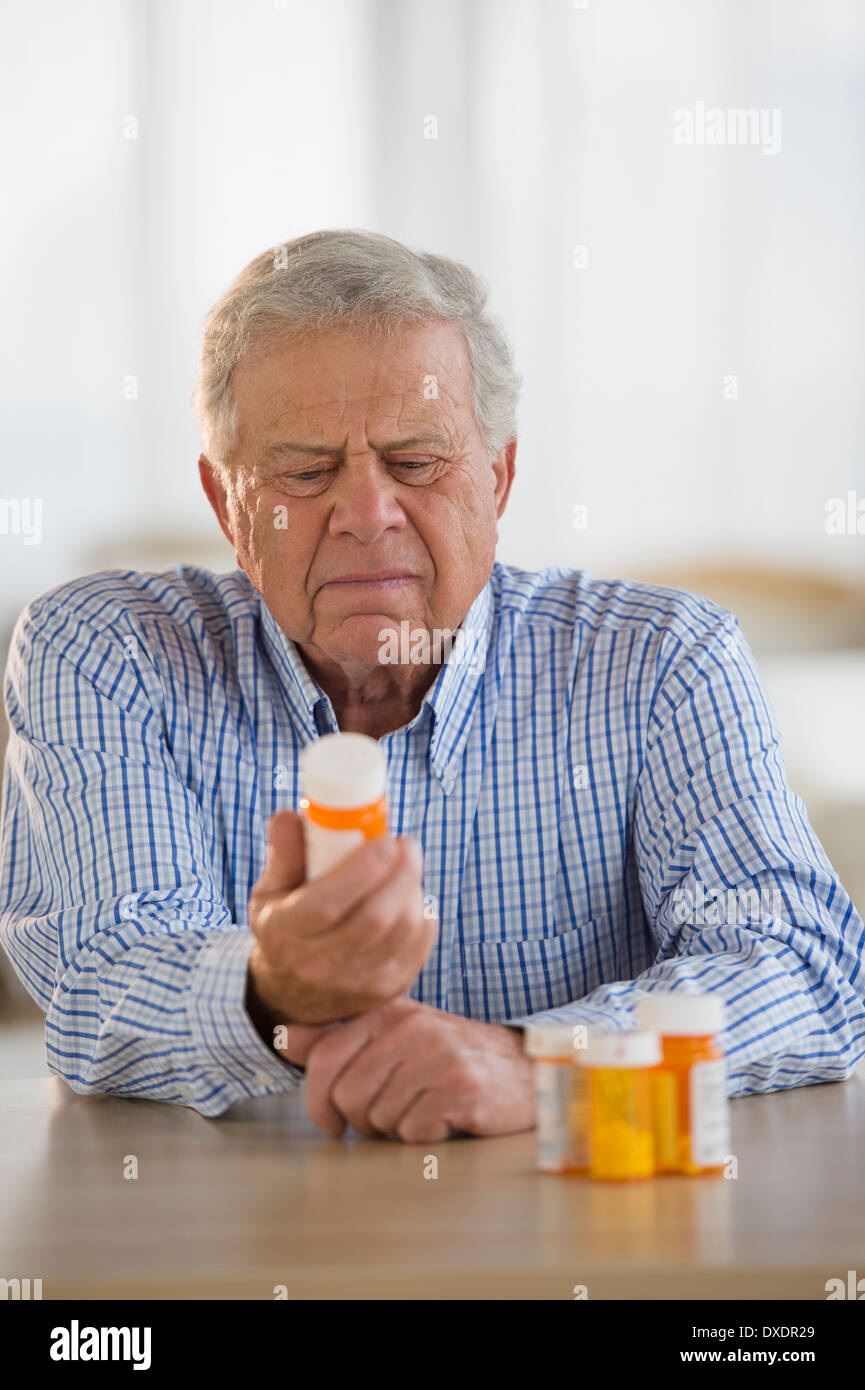 Senior man holding pill bottle Stock Photo Alamy