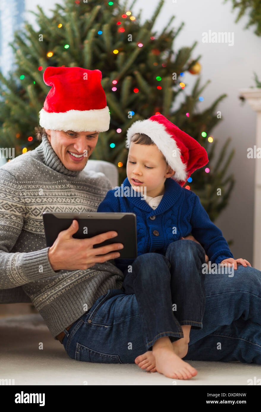Father and son (6-7) using tablet Stock Photo