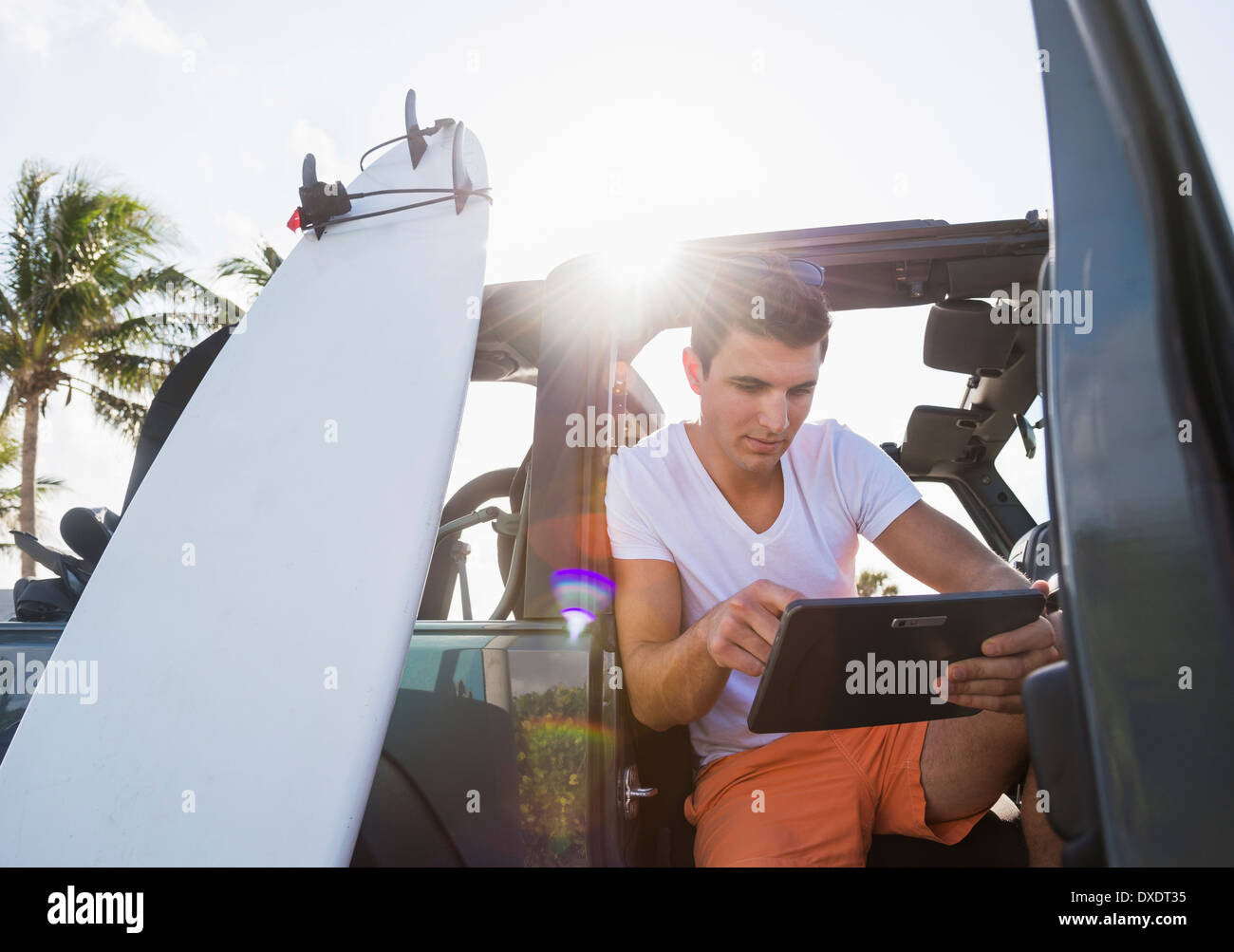 Young man using digital tablet, Jupiter, Florida, USA Stock Photo