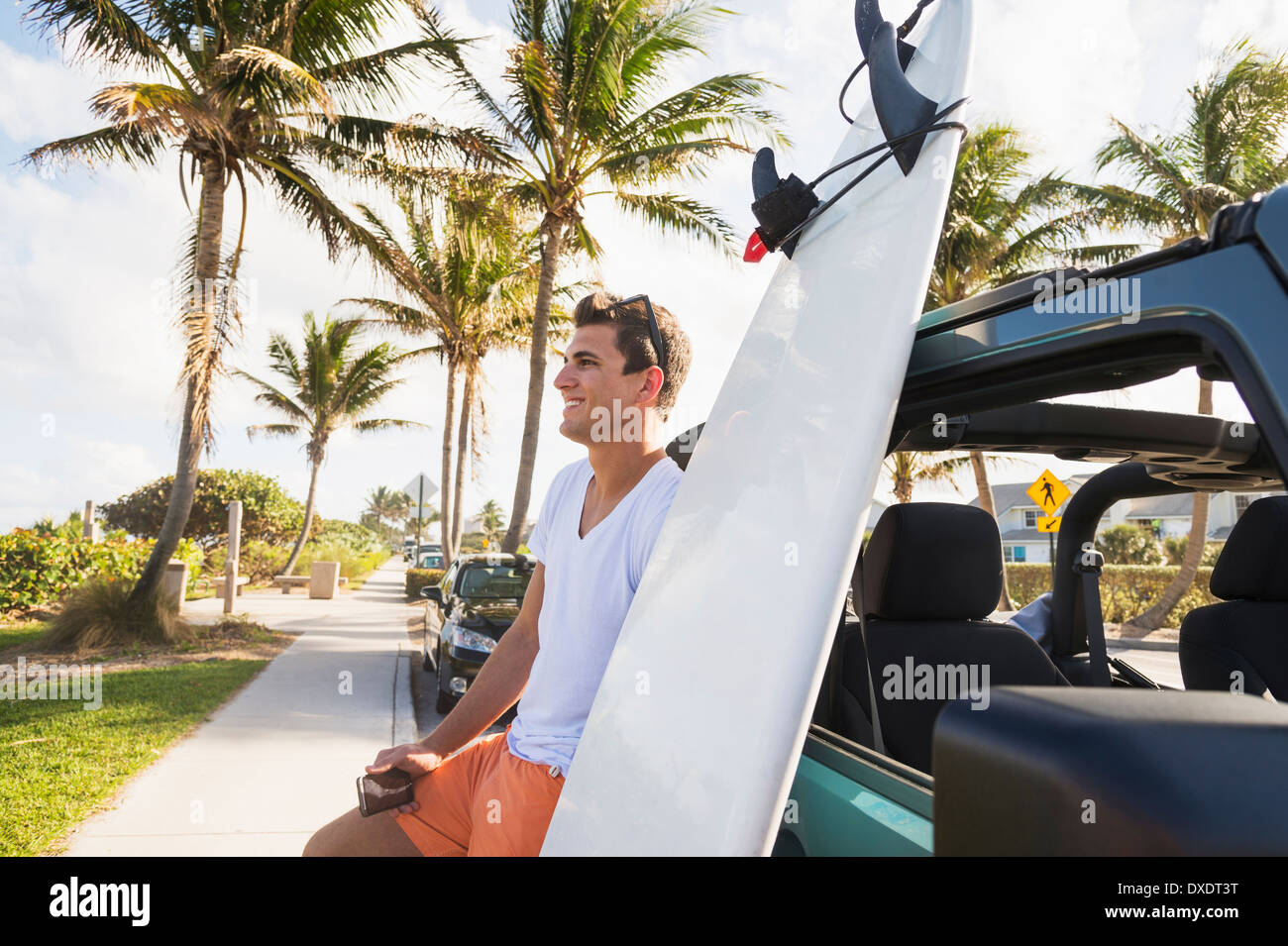 Young man holding mobile phone, Jupiter, Florida, USA Stock Photo