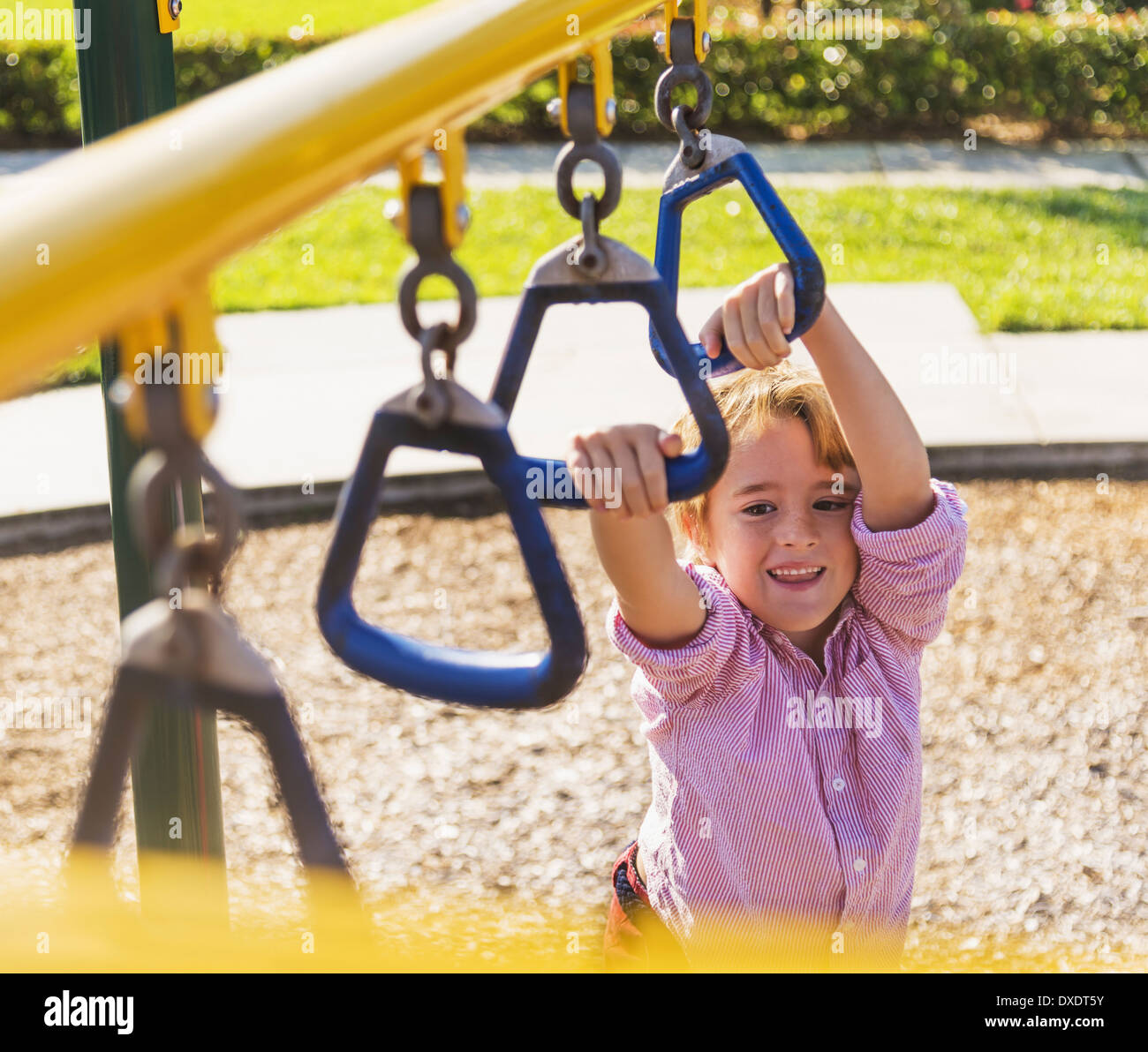 Boy (8-9) playing on playground, Jupiter, Florida, USA Stock Photo