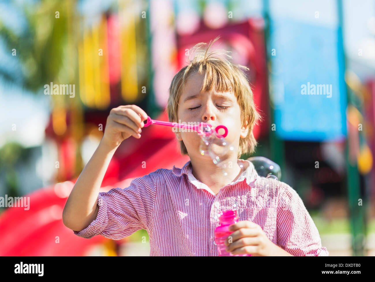 Boy (8-9) blowing bubbles, Jupiter, Florida, USA Stock Photo