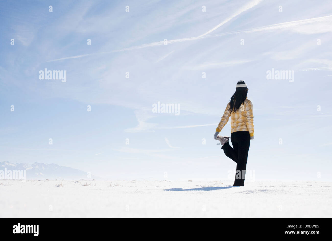 Woman stretching on snow, Colorado, USA Stock Photo - Alamy
