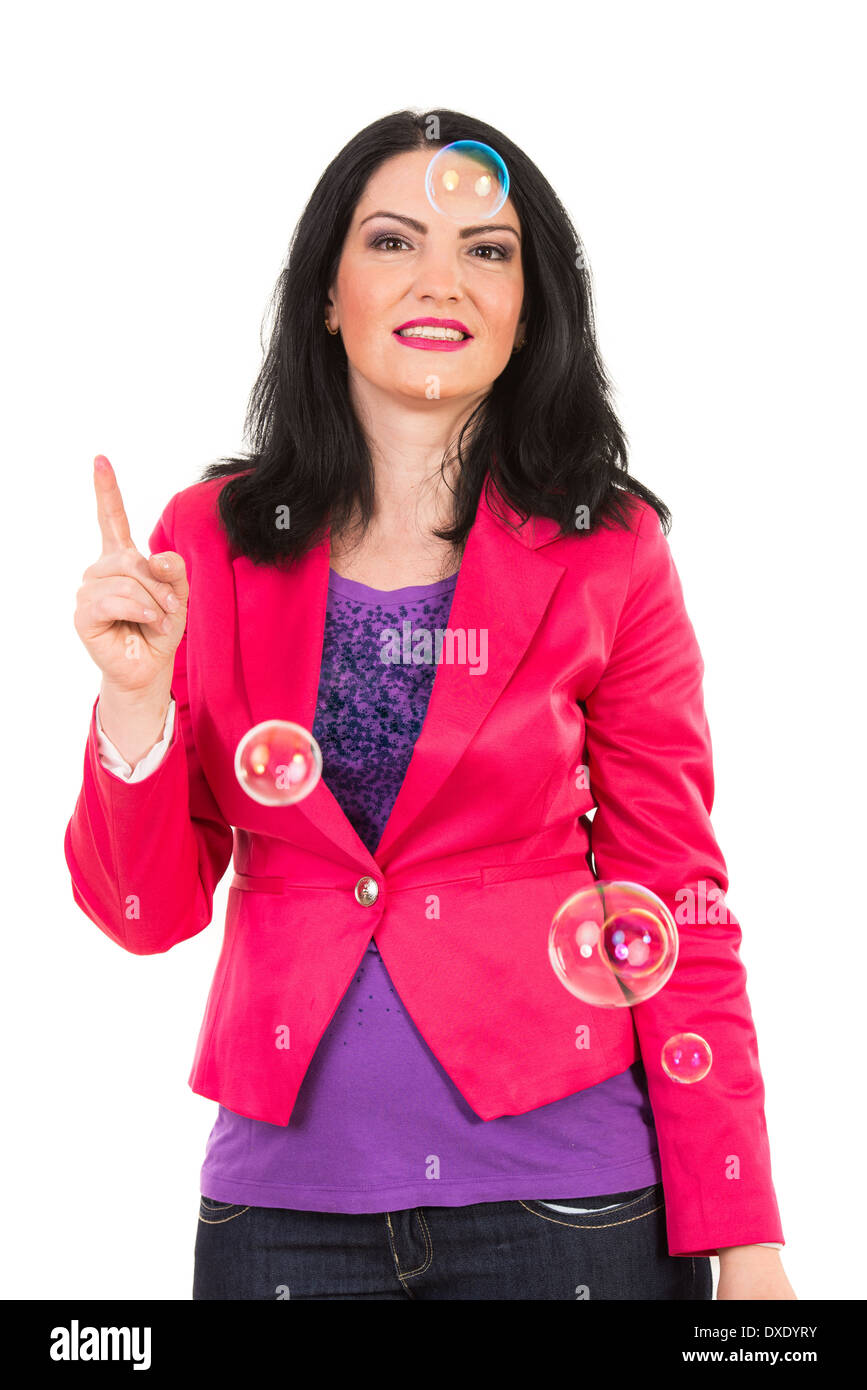 Happy woman with soap bubbles around her pointing up isolated on white background Stock Photo