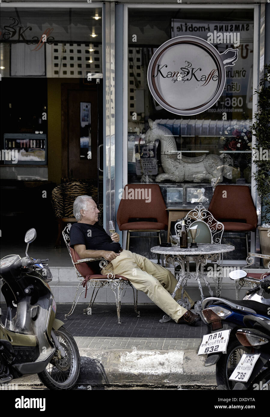 Street café with man relaxing and drinking alcohol and contented. Thailand Southeast Asia Stock Photo