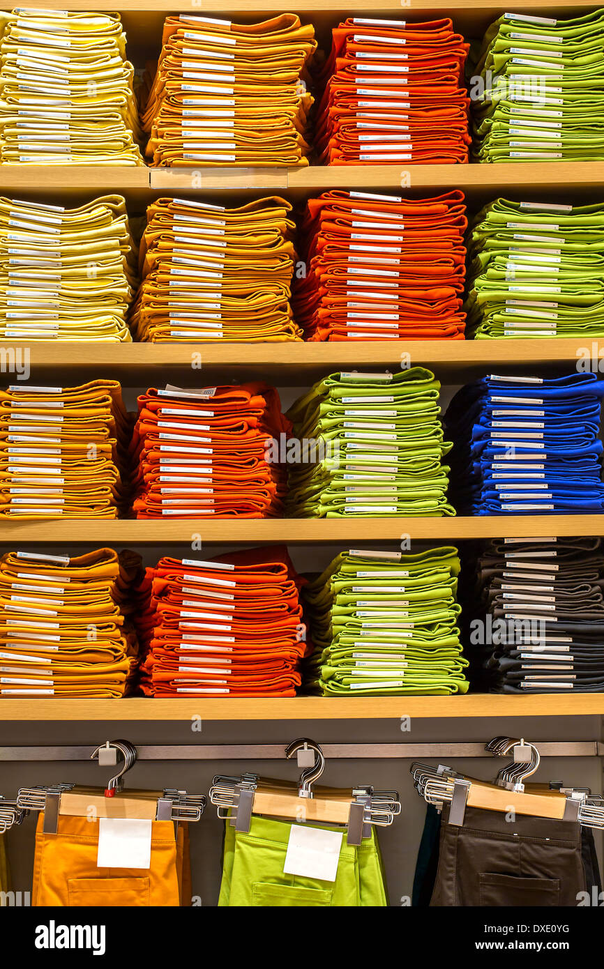 Neat stacks of folded clothing on the shop shelves Stock Photo Alamy
