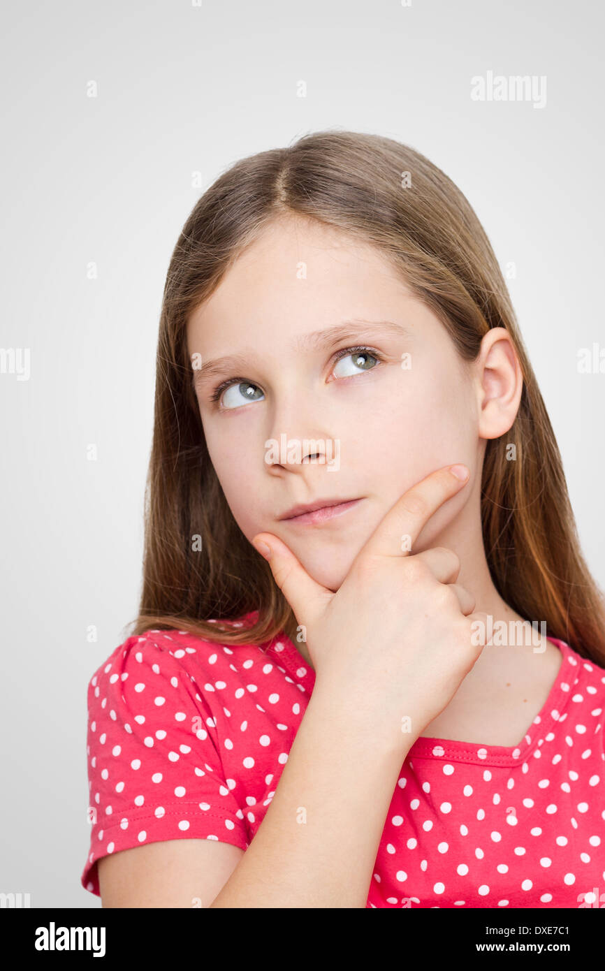 pensive girl with dotted red shirt Stock Photo