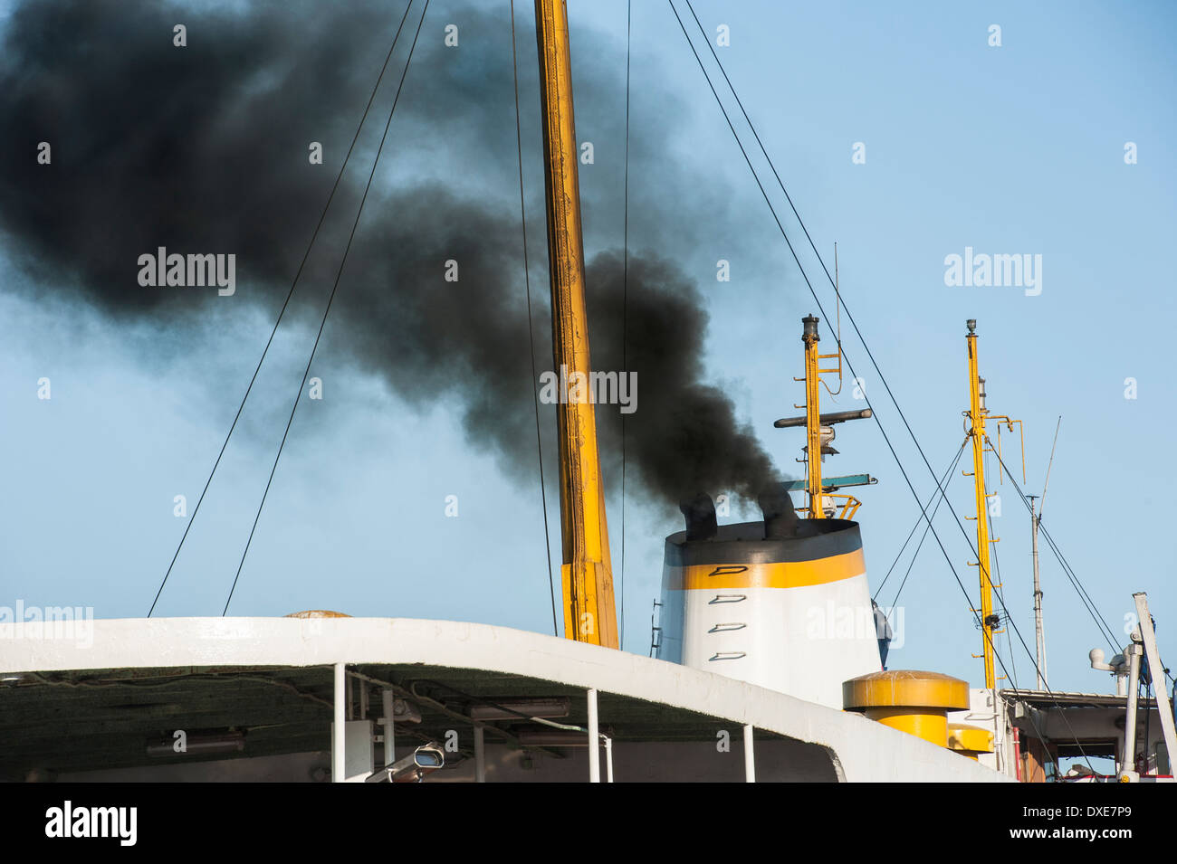 Black exhaust smoke coming from ship smoke stack funnel air pollution concept Stock Photo
