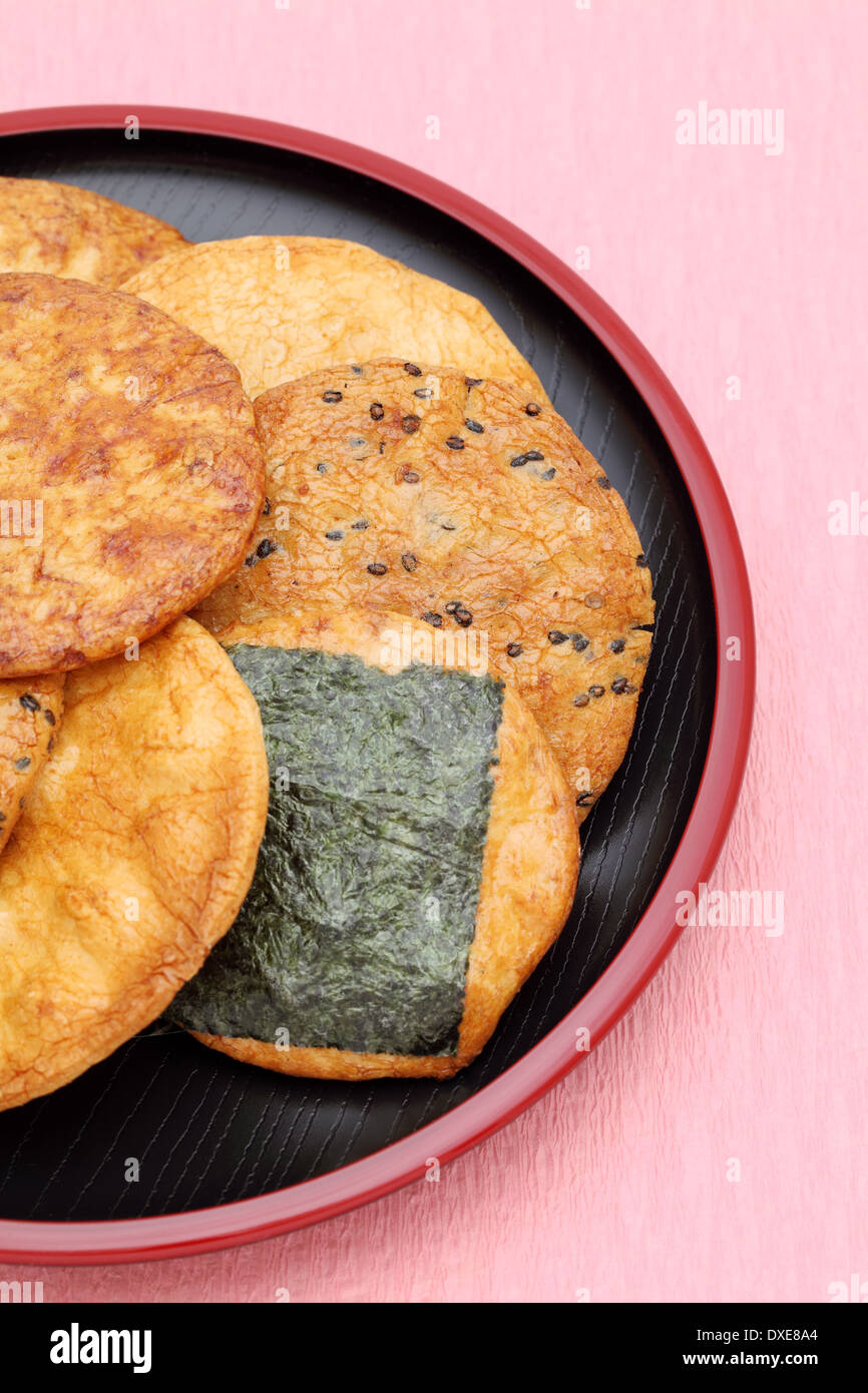 Japanese rice cracker on plate, pink background Stock Photo - Alamy