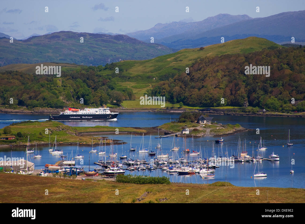 M.V.Clansman passes ardentrive marina and Dunollie Castle as she enters Oban Bay, Argyll Stock Photo