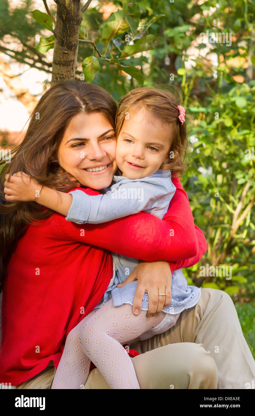 Mother and daughter hugging in the park. Stock Photo