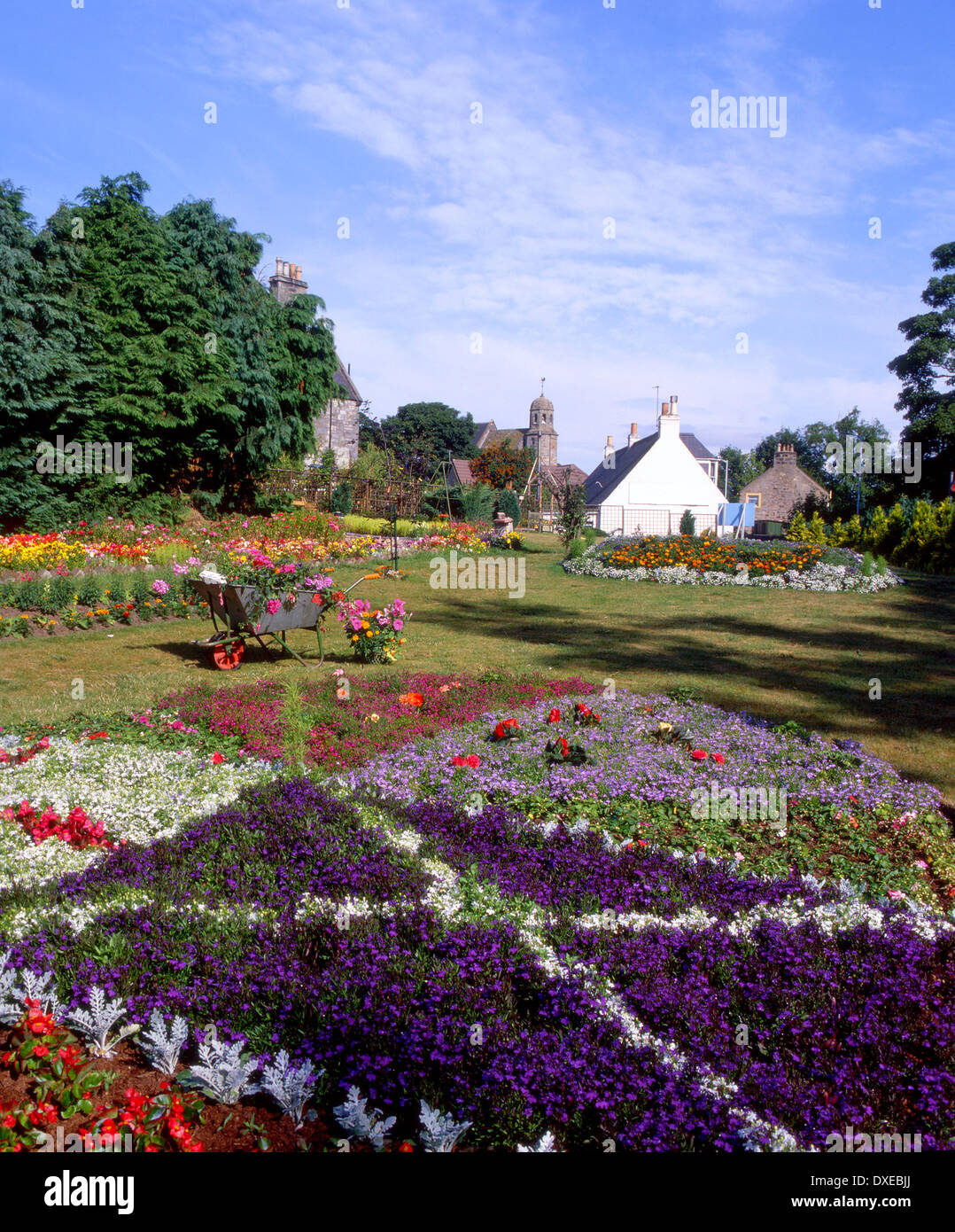 Beautiful garden in the village of Leuchars with St Athernase roman church,Fife Stock Photo