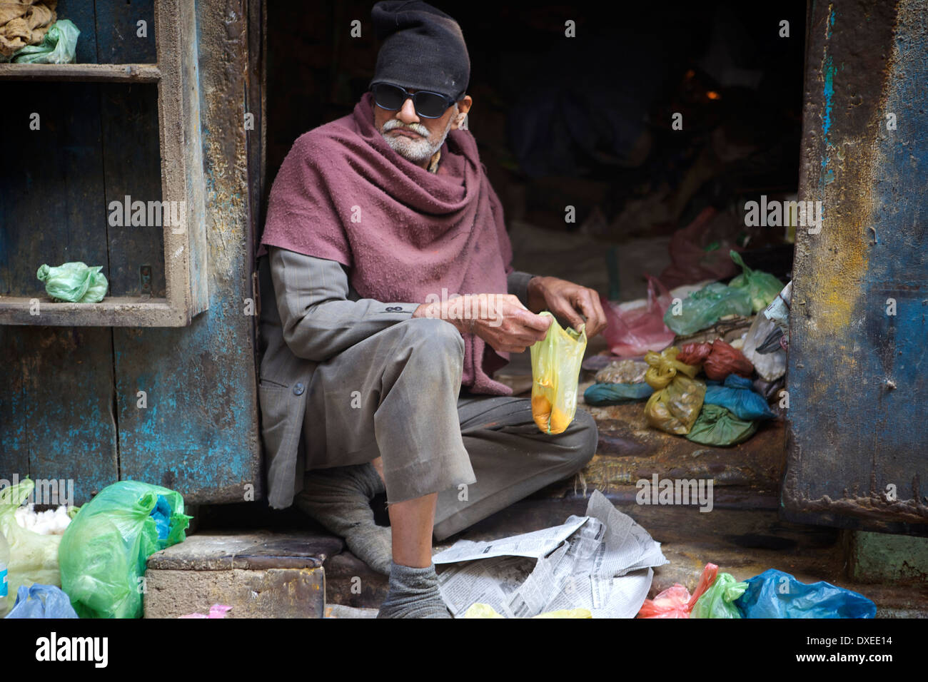 Old Indian man selling his goods Stock Photo