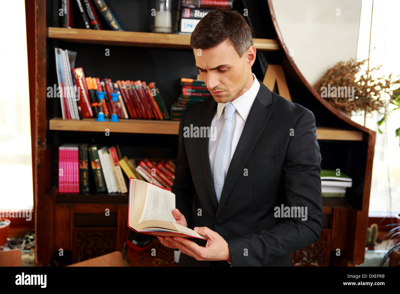 Businessman reading the book Stock Photo