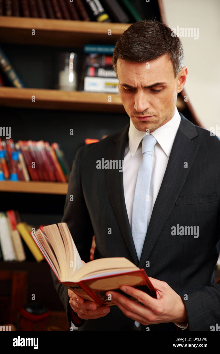 Businessman reading the book in library Stock Photo