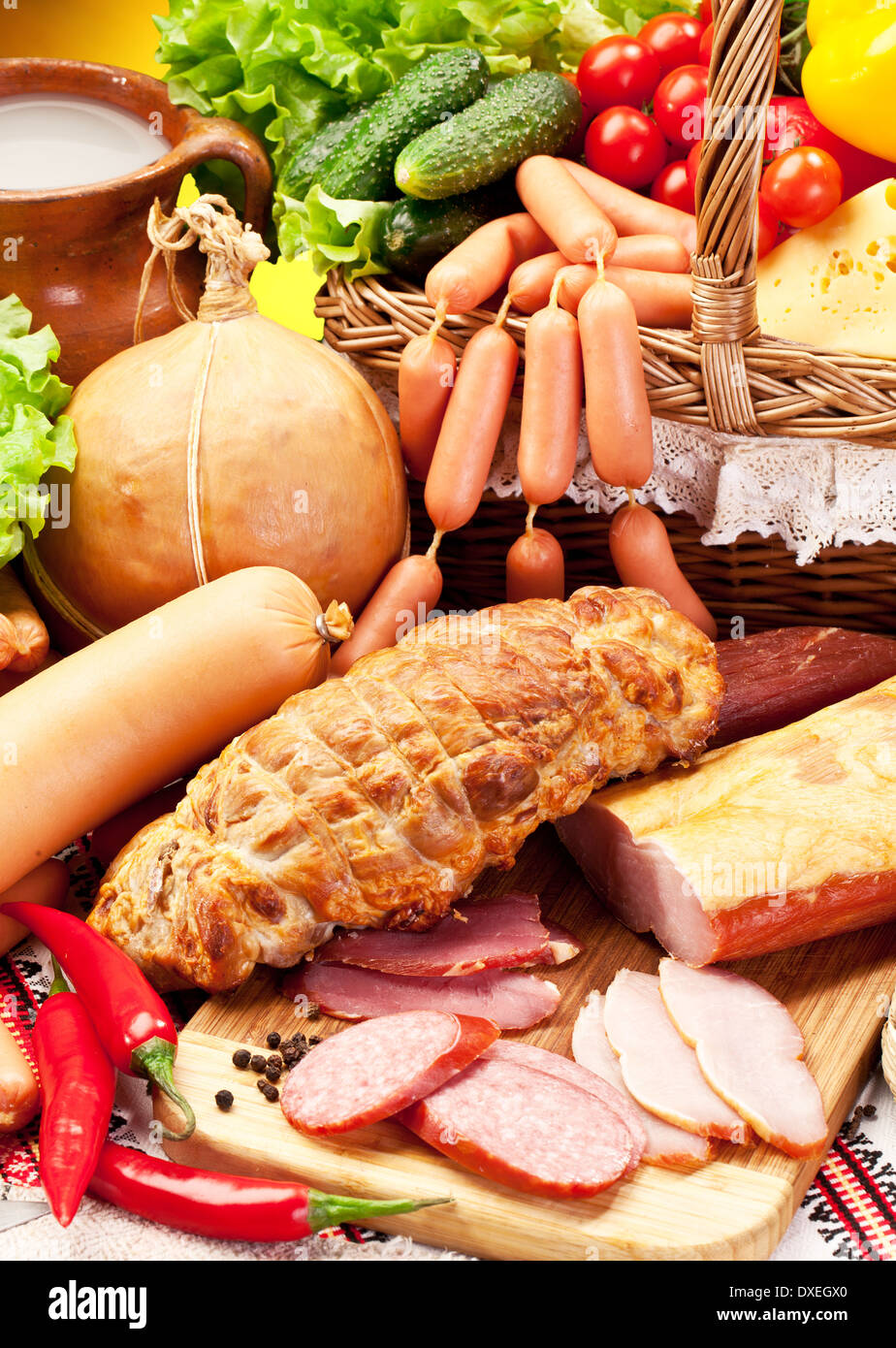 Variety of sausages with vegetables and milk products. Stock Photo