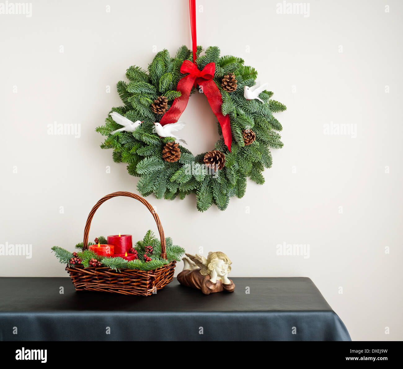 Advent wreath over side board with angel and candle Stock Photo