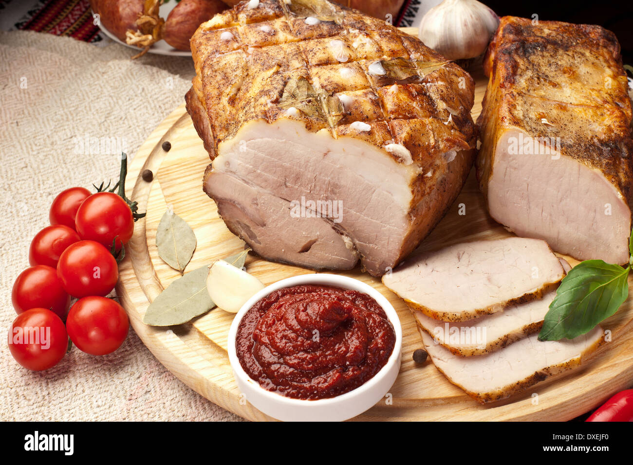 Different types of home-made pork arranged with sauce and vegetables. Stock Photo