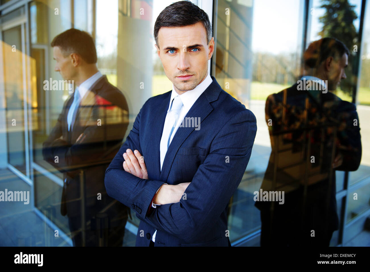 Portrait of a confident businessman standing with arms folded Stock Photo