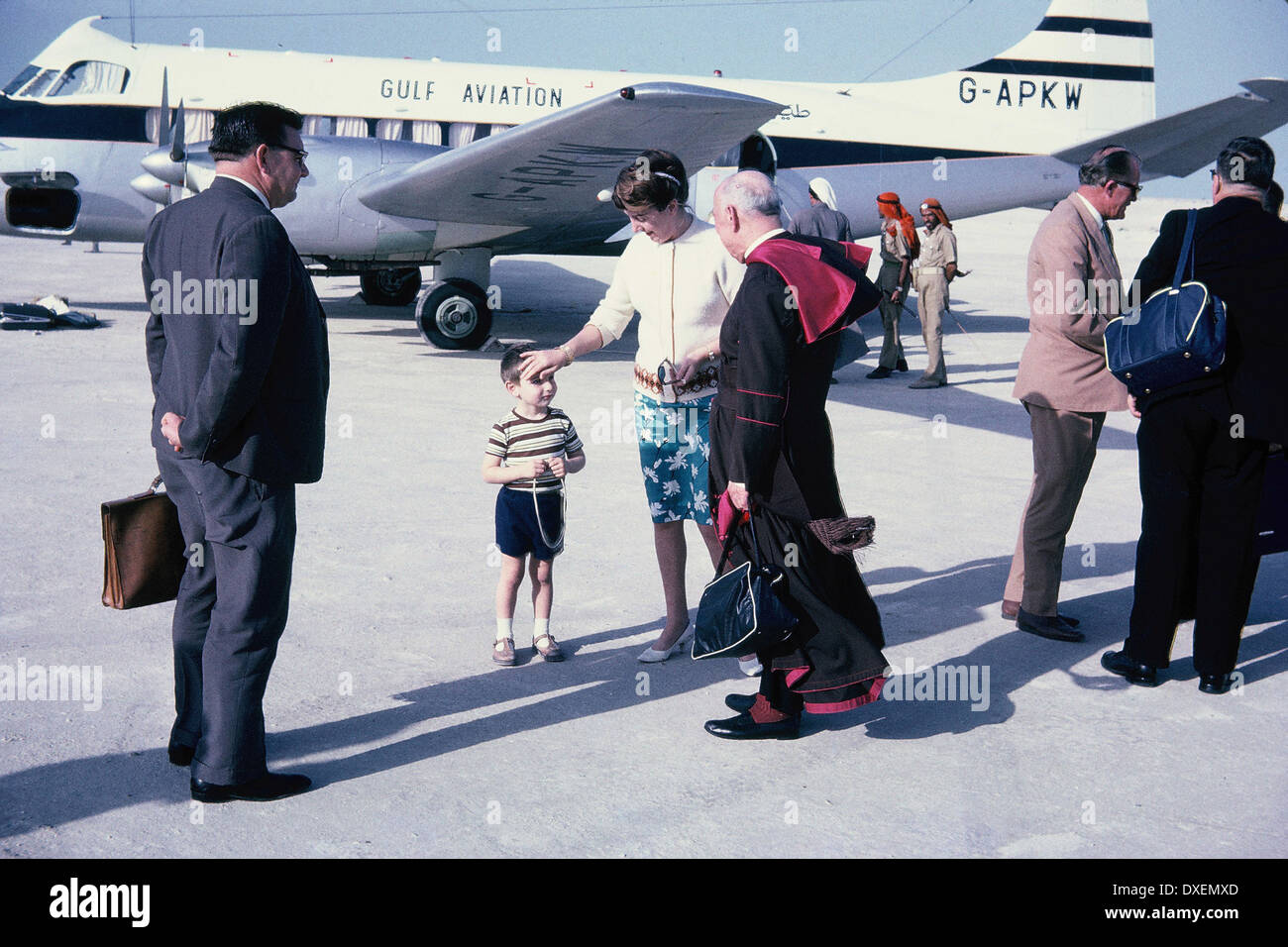 Passengers, including the Papal Nuncio, boarding a Gulf Aviation plane at Abu Dhabi, 1965 Stock Photo