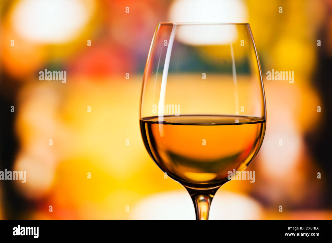 glass with white wine , focus on foreground Stock Photo