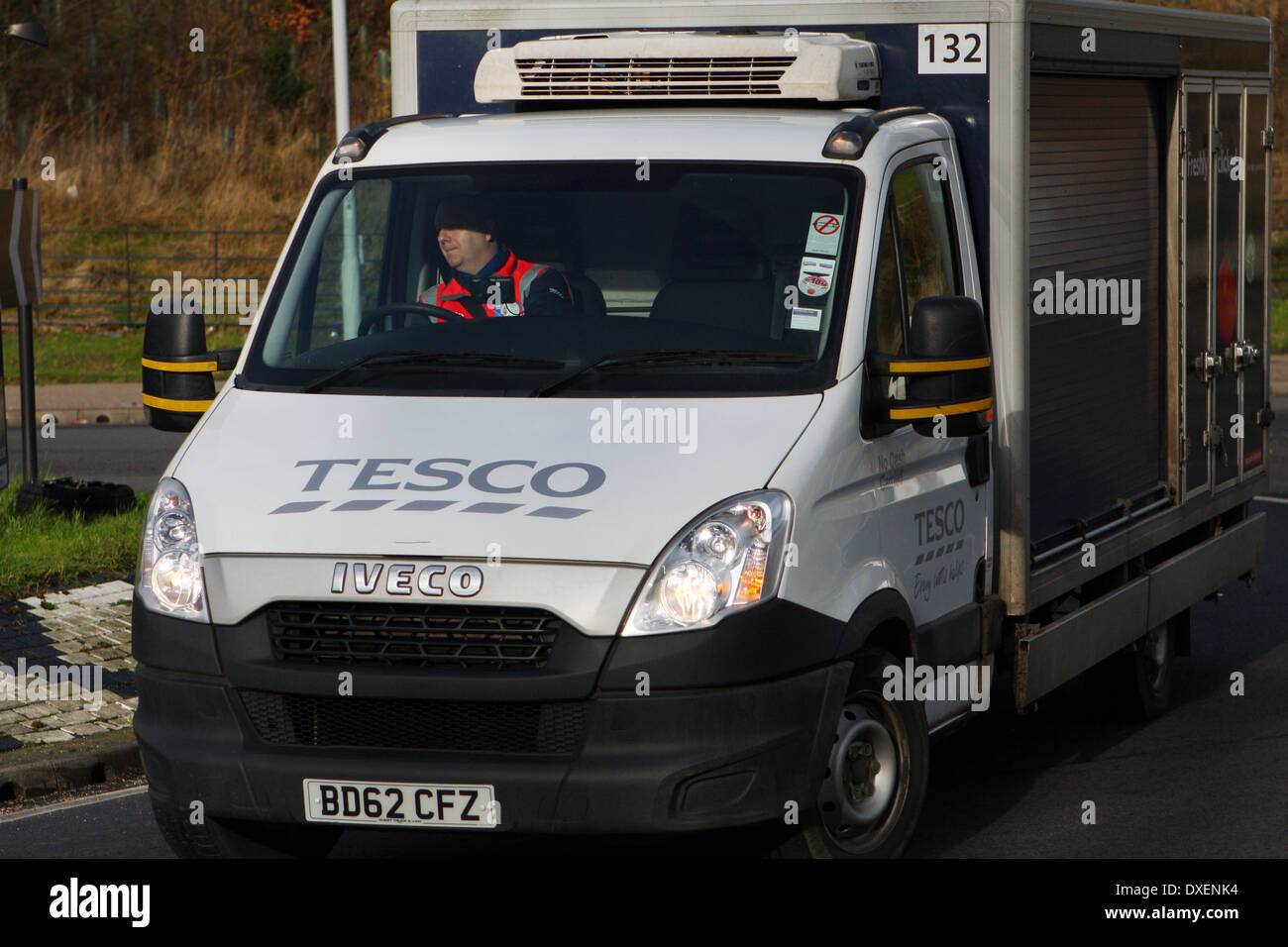 A Tesco delivery truck driving around a roundabout in Coulsdon, Surrey, England Stock Photo