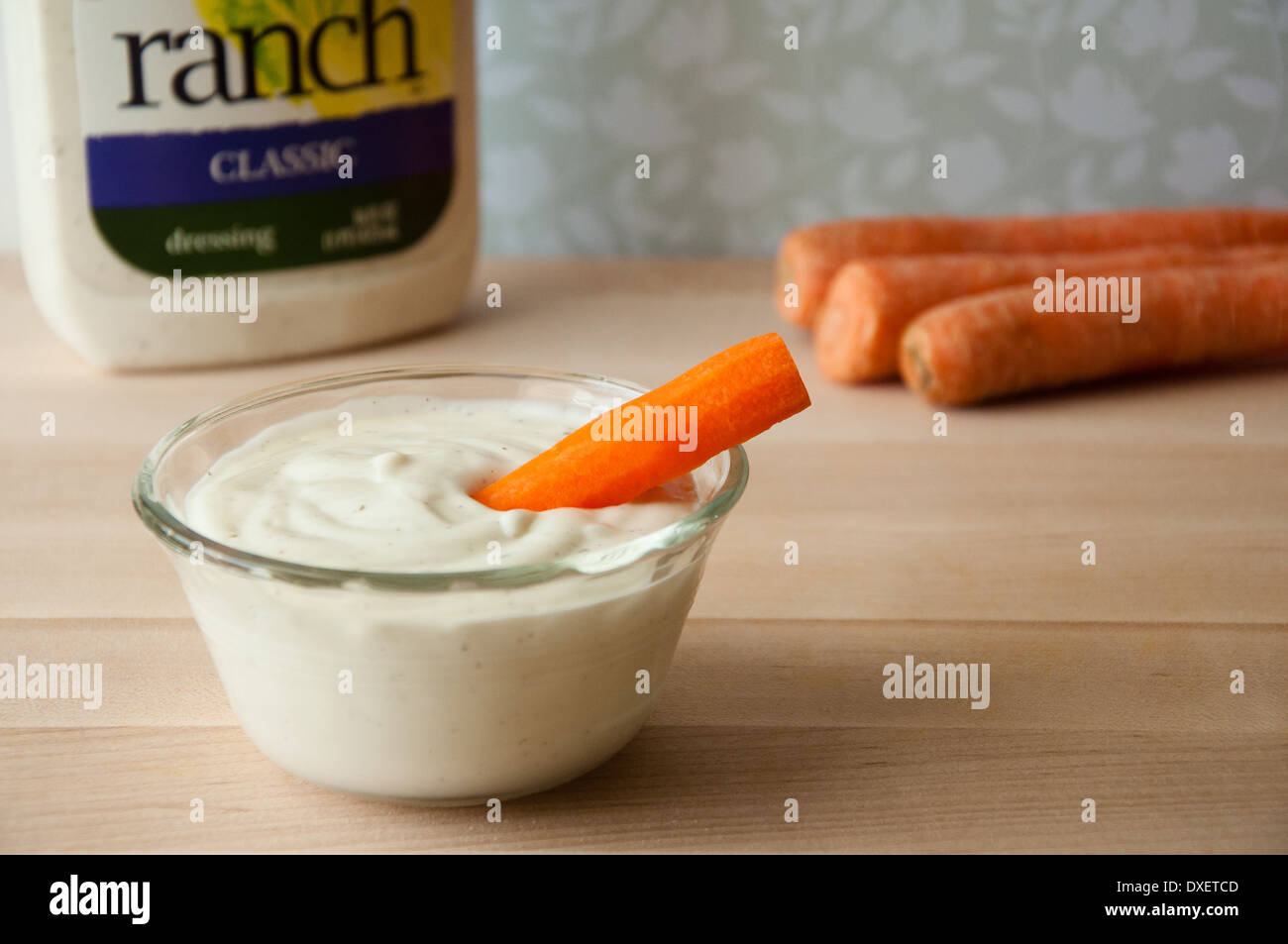 Carrot stick in ranch dressing Stock Photo Alamy