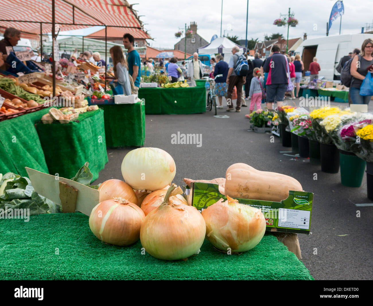 Large onions on fruit and veg stall at open air market in Sheringham