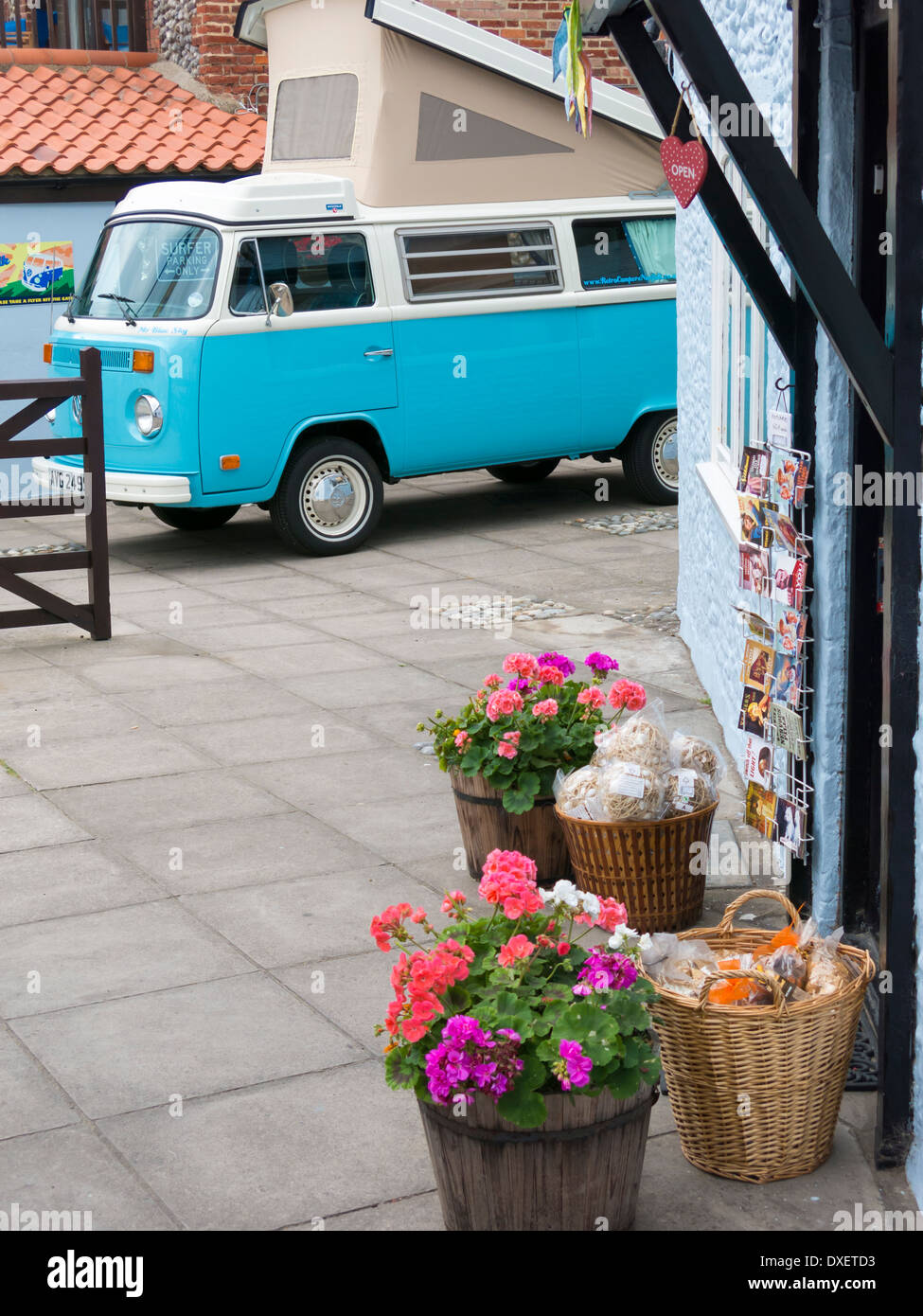 VW Blue and white camper van in background with  flowers on the  door step Norfolk England Stock Photo