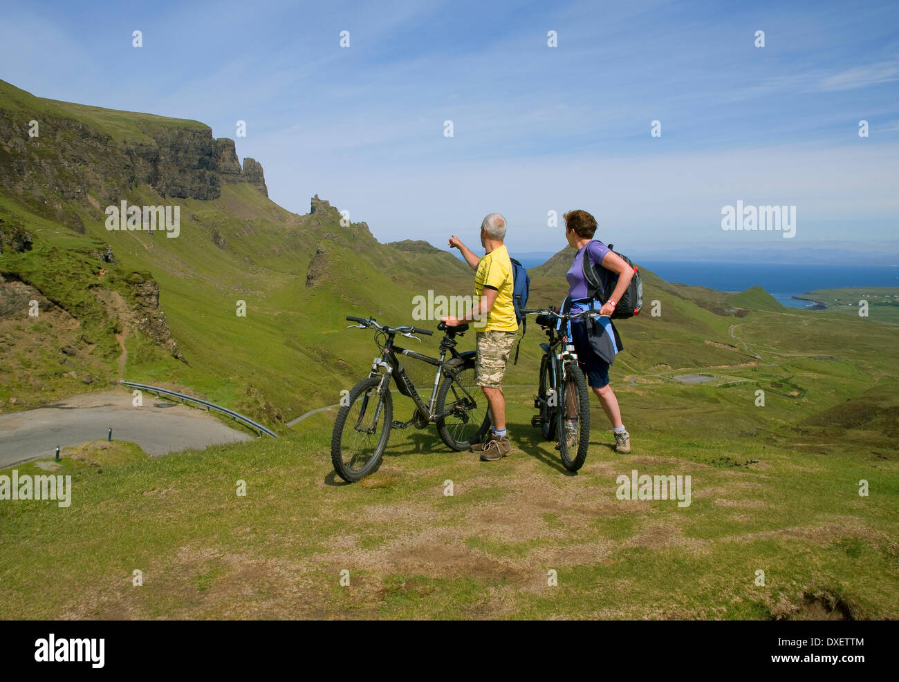 Cyclists pause to take in the magnificent view at the Quiraing pass, Isle of Skye. Stock Photo