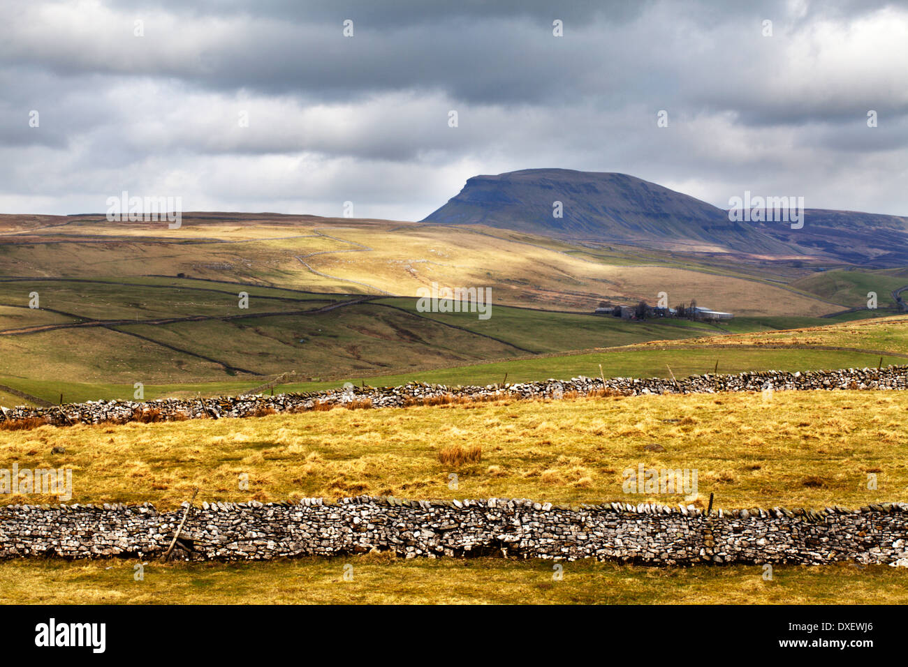 Light breaks through Dark Clouds over Pen Y Ghent near Settle Yorkshire Dales England Stock Photo