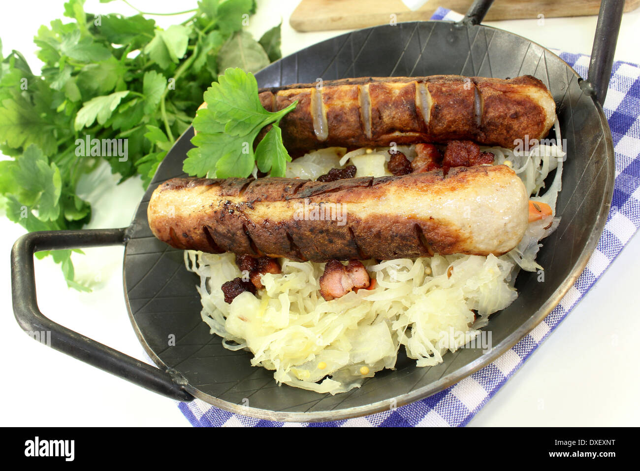 a pan with sourcrout and fried sausage Stock Photo