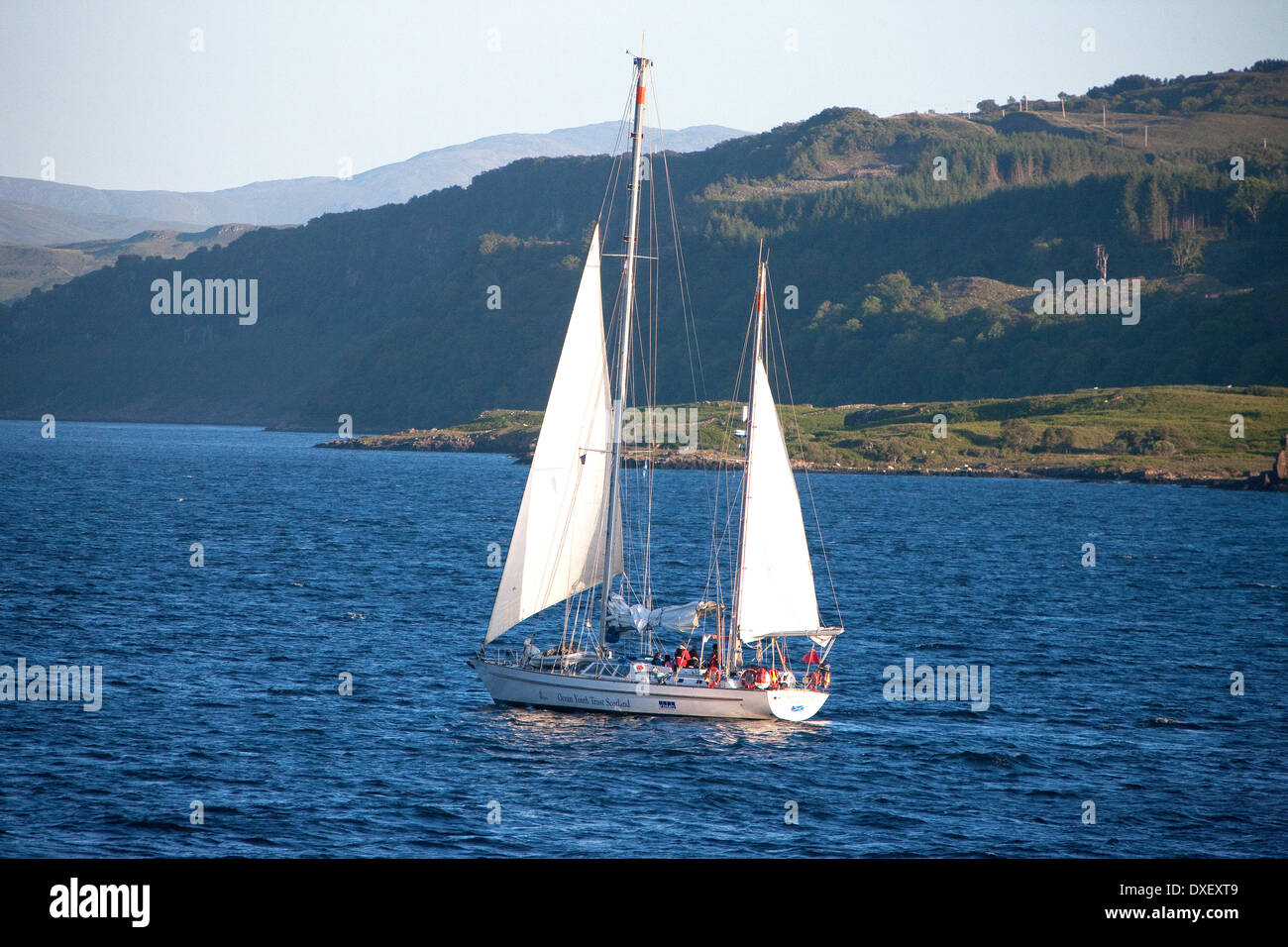 yacht sails past the island of mull coastline in the sound of mull.argyll. Stock Photo