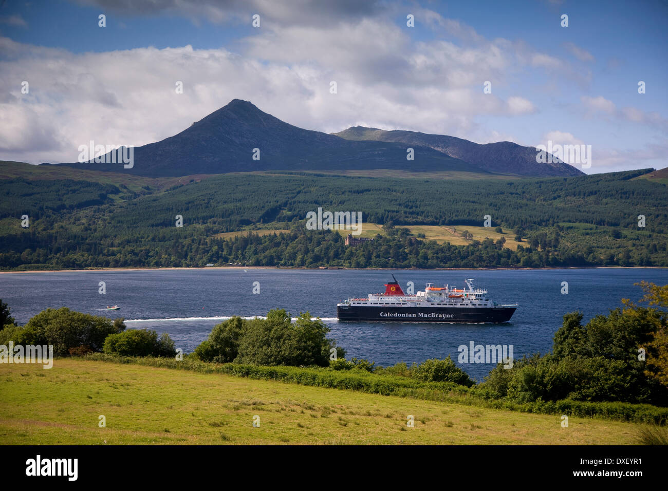 The M.V.Caledonian Isles departing Brodick bay with Goatfell and Brodick Castle in view, Isle of Arran. Stock Photo