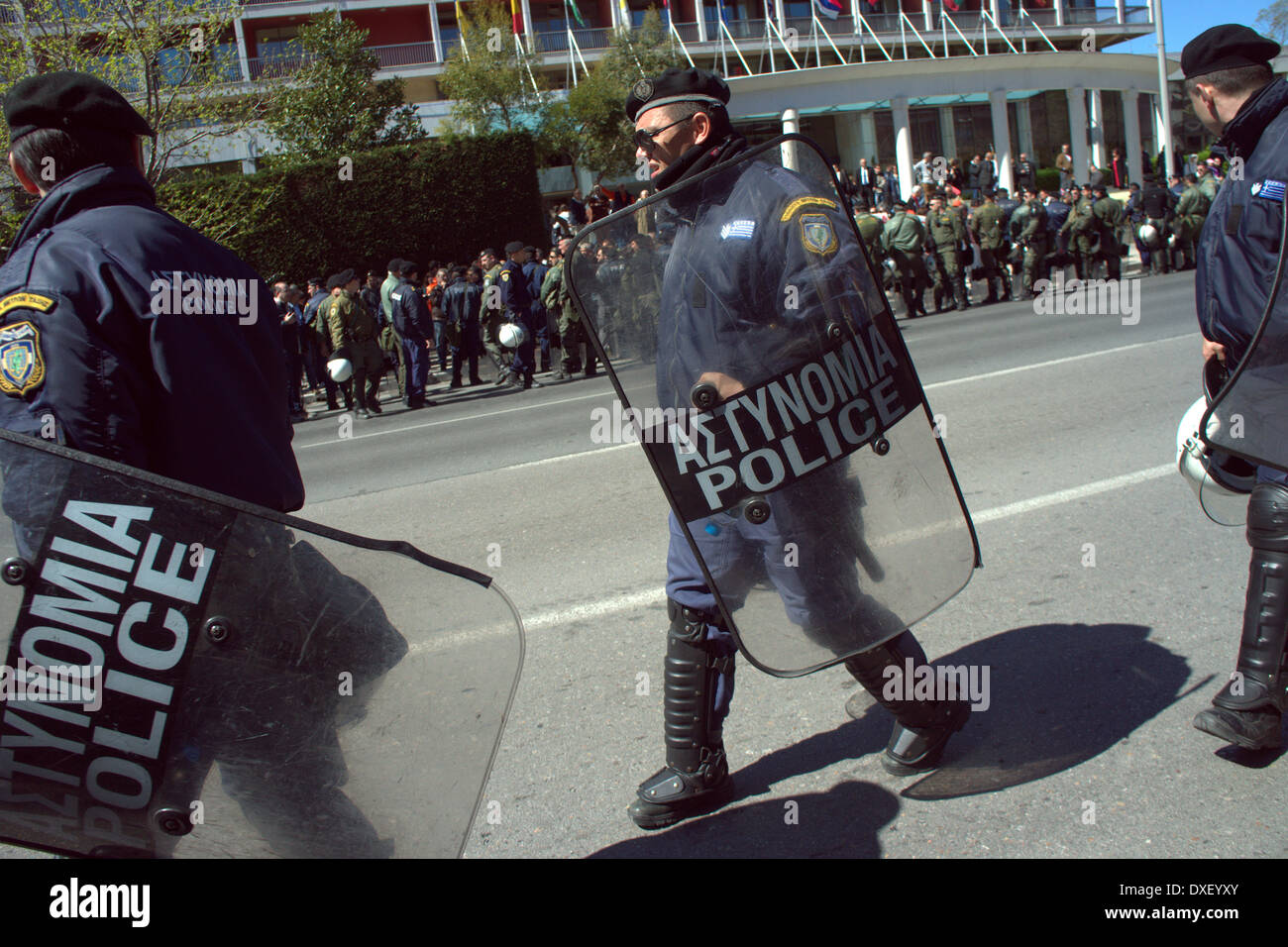 Thessaloniki, Greece. 25th March 2014.  Greek riot police walking around the street perimeter during the annual parade on Tuesday, celebrating the Greek independence day, in the northern Greek port city of Thessaloniki. Greeks celebrated their national independence day amid tight security and protest in the northern port city of Thessaloniki, as school teachers staged a protest against planned layoffs as part of governments cost cutting reforms.  Credit:  Orhan Tsolak/Alamy Live News Stock Photo