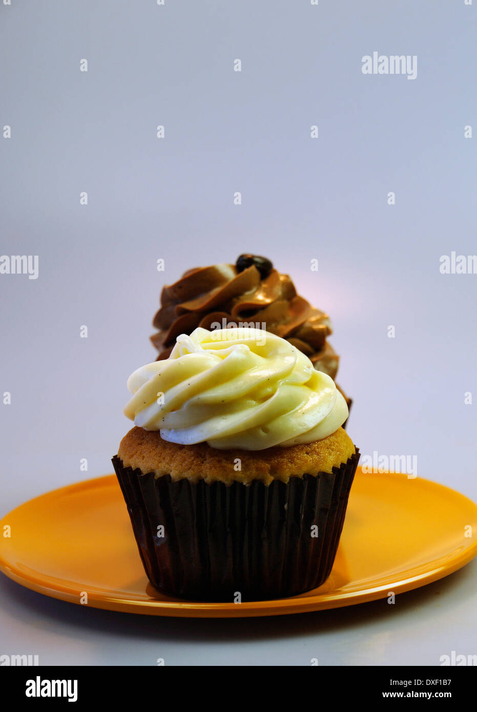 Banana And Chocolate Cupcakes On Plate In Studio Stock Photo