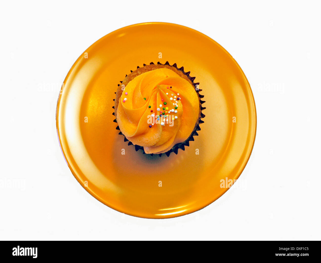 Overhead Of Single Orange Cupcake With Icing Stock Photo