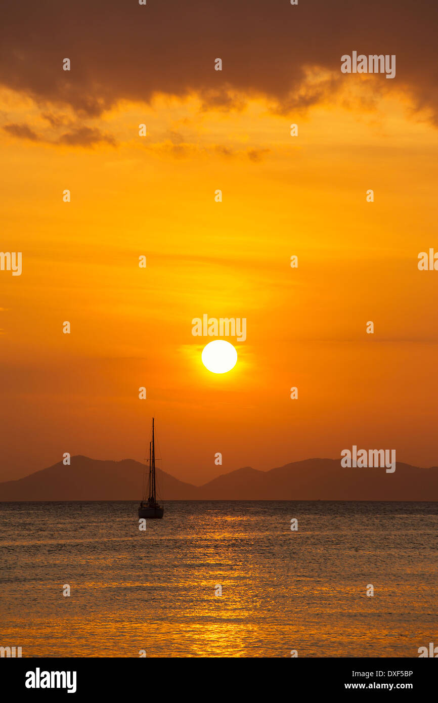 Yacht in the sea at sunset Stock Photo - Alamy