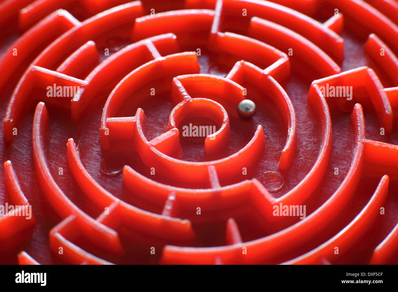 Close up of a small, toy maze. (This is the centre of a small, circular maze which is only 80mm in diameter). Stock Photo