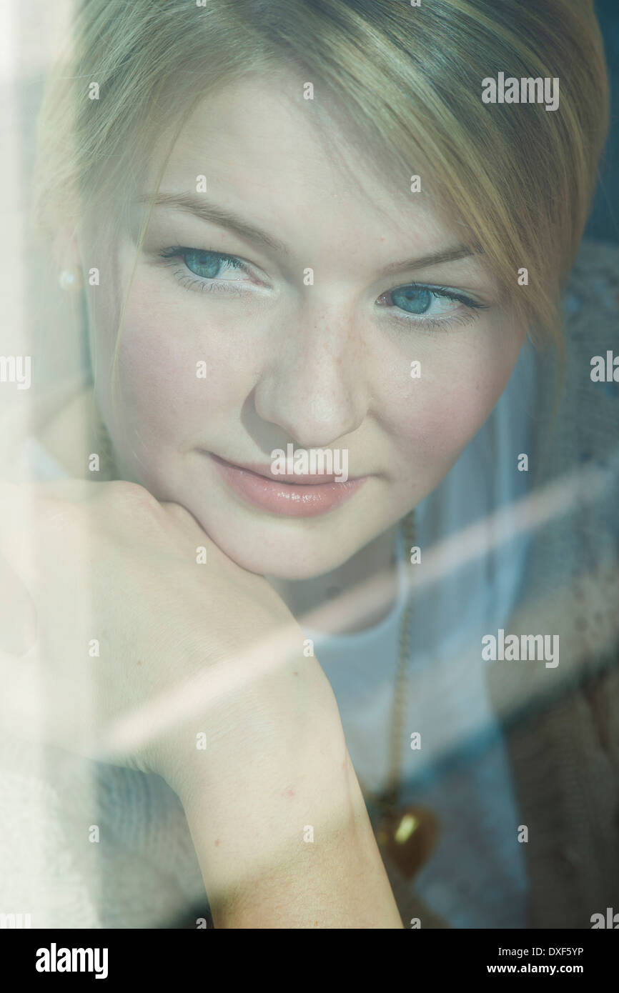 Young woman looking out window hires stock photography and images Alamy