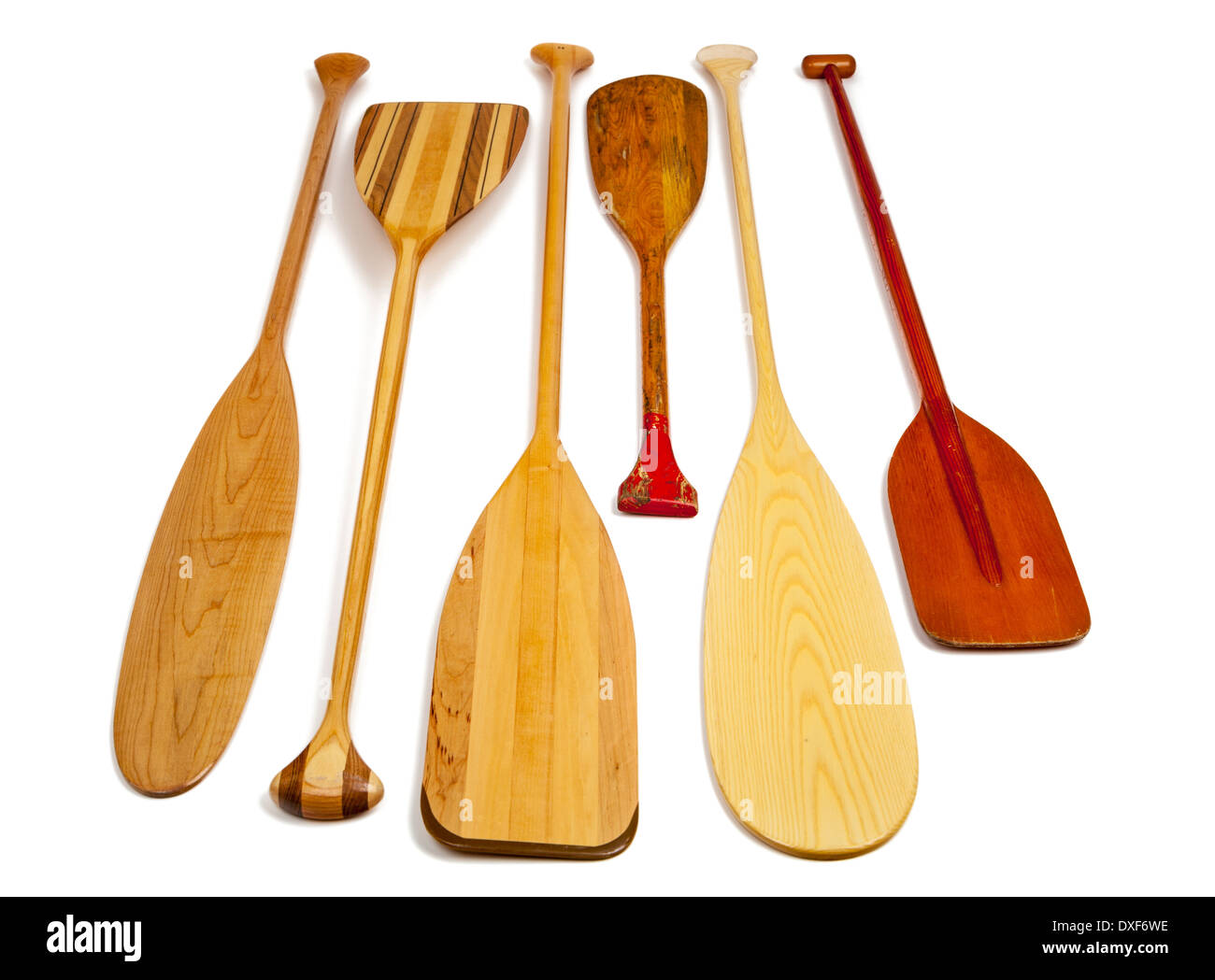 wooden canoe paddles of different shapes and sizes including a classic