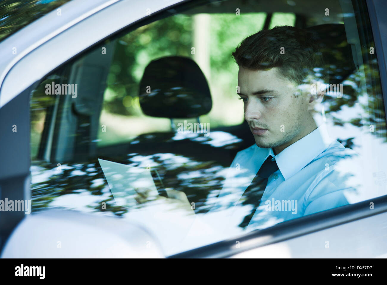 Businessman working on Tablet Computer in Car, Mannheim, Baden-Wurttemberg, Germany Stock Photo