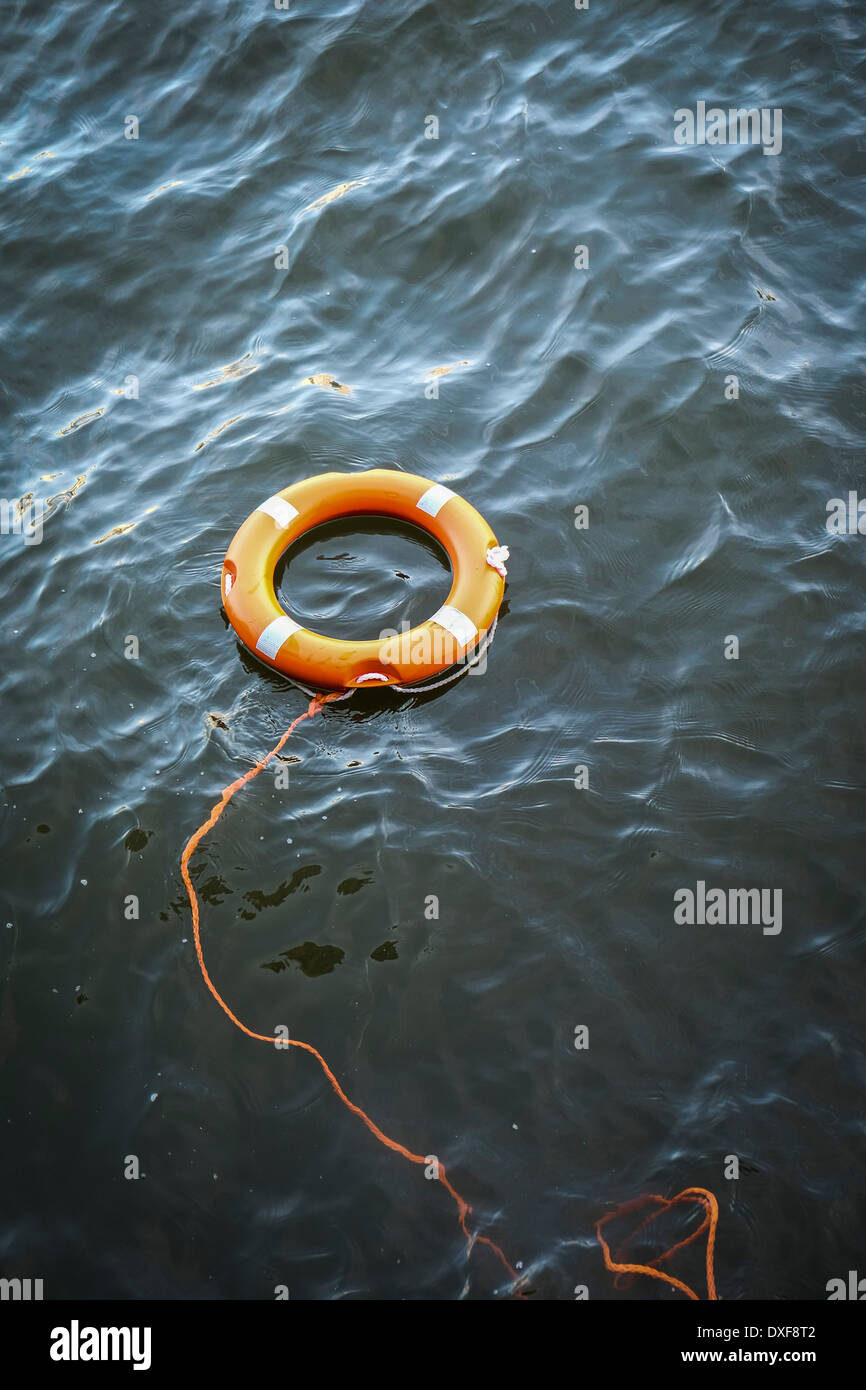 A lifebelt floating in the River Thames. Stock Photo