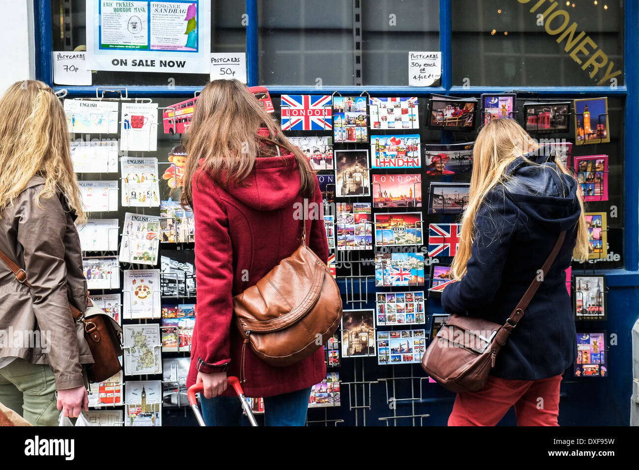 Tourists buying postcards. Stock Photo