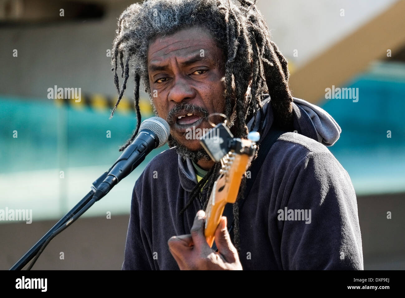 A Rastafarian busker performing on the South Bank in London. Stock Photo