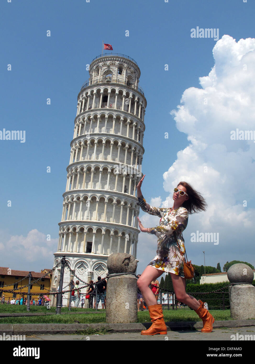 Italy, Tuscany, Pisa, Girl posing by Leaning Tower of Pisa Stock Photo