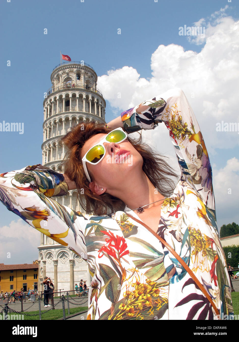 Italy, Tuscany, Pisa, Girl posing by Leaning Tower of Pisa Stock Photo