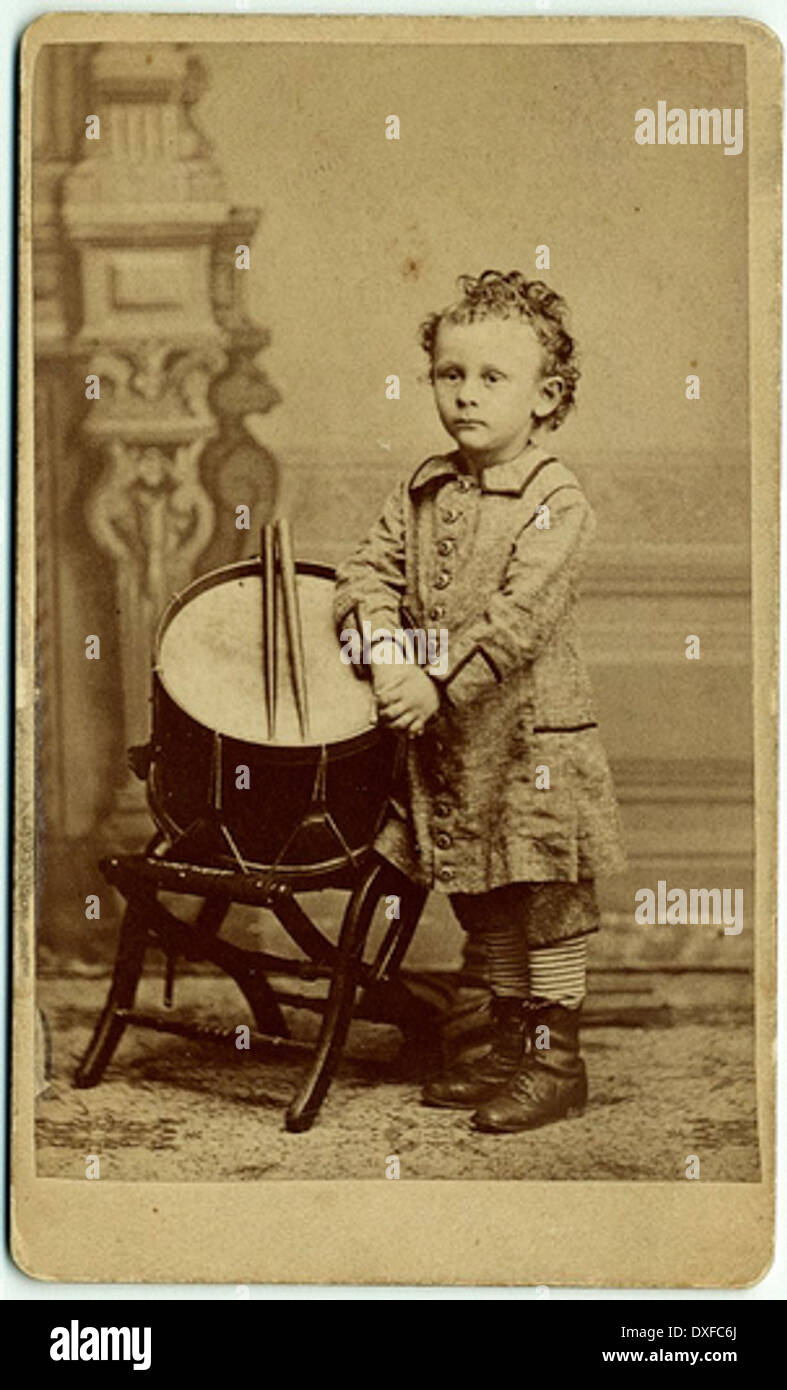 Portrait of Hine as small child standing by drum Stock Photo